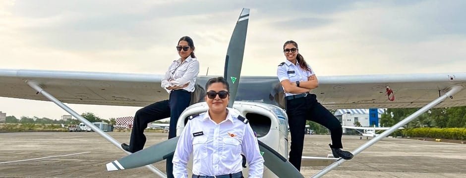 Group of female student pilots posing in front of aircraft