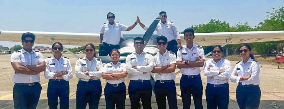 Group of student pilots posing in front of aircraft